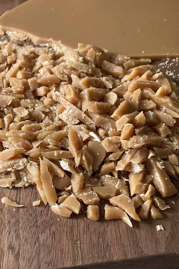 easy homemade toffee bits being chopped on a wooden cutting board