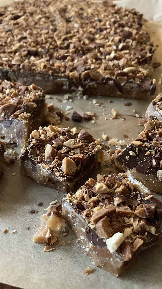 buttery homemade english toffee coated with chocolate and almonds broken into bite-sized pieces