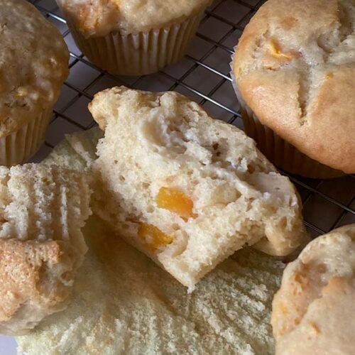 close-up of the inside of a peaches and cream muffin showcasing the moist crumb