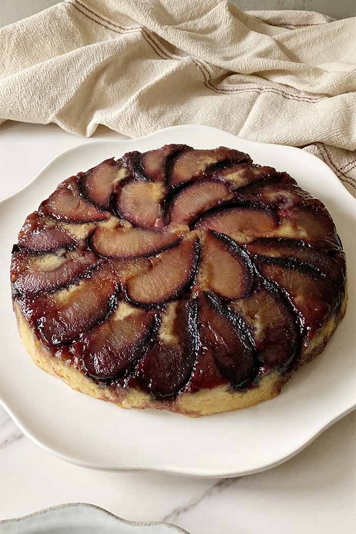 easy almond plum upside-down cake on plate