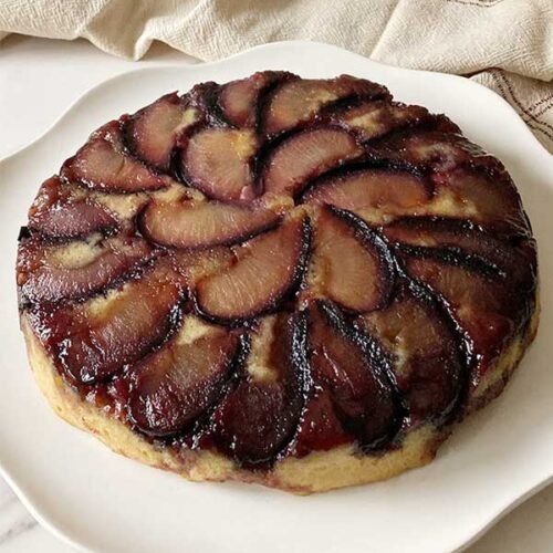 fancy almond plum upside down cake on plate
