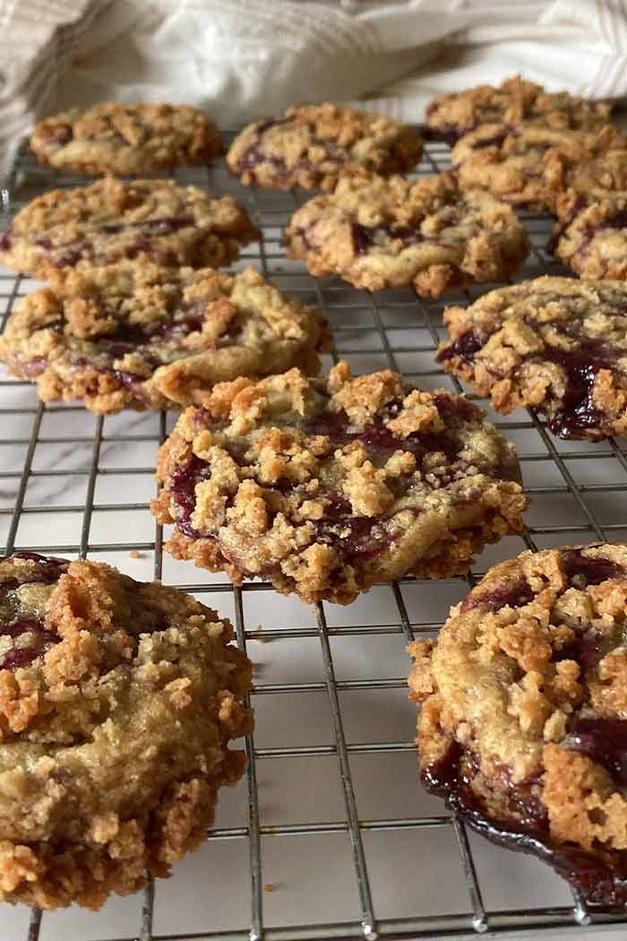 blueberry muffin cookies with streusel topping on a cooling rack