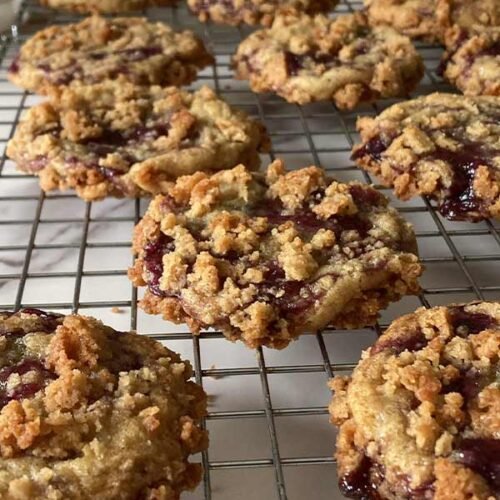 blueberry muffin cookies with streusel topping on a cooling rack