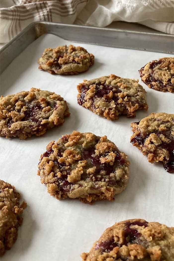 blueberry muffin cookies with streusel topping on a baking sheet