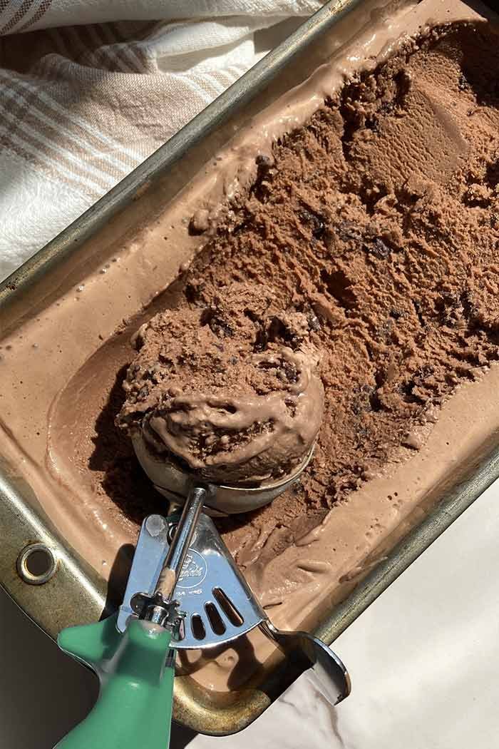 scooping mocha cookie crunch ice cream revealing the texture