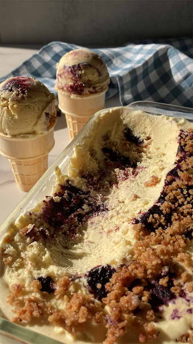 homemade blueberry muffin ice cream with streusel scooped to show texture