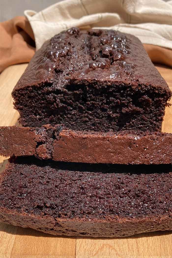 sliced chocolate espresso loaf cake, head-on to show the moist and tender inside texture