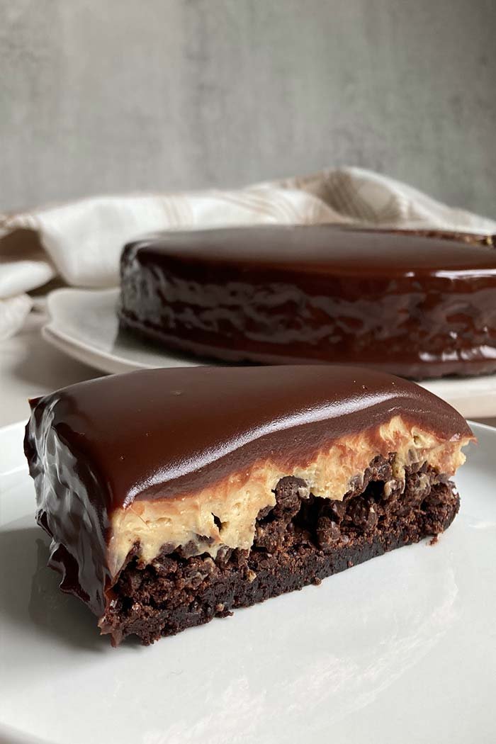 slice of peanut butter mousse brownie crunch cake layered dessert
